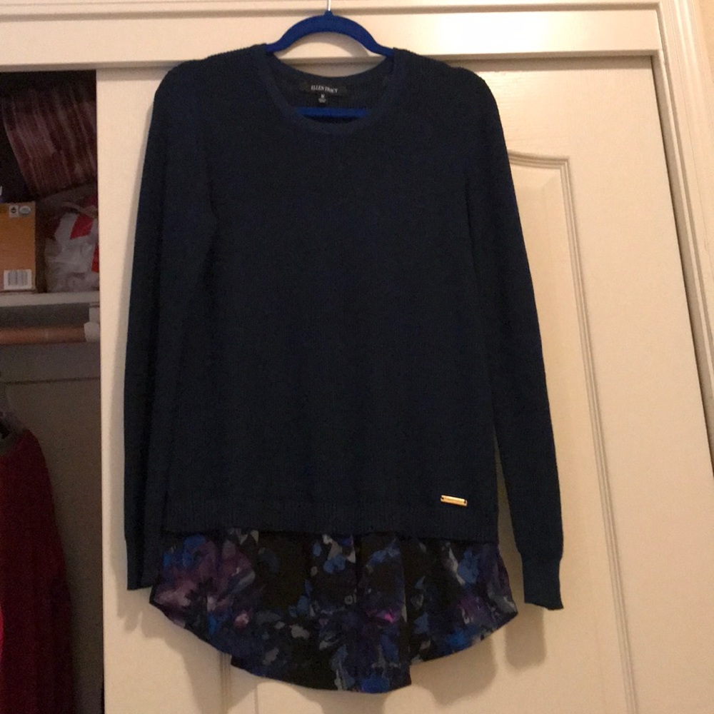 Navy pullover sweater with fabric ruffle.